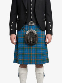 Person wearing a black jacket, blue plaid kilt, and white knee-high socks on a white background