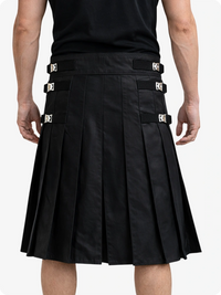 Black kilt worn by a person on a white background