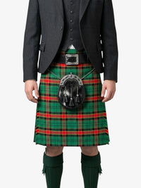 Person wearing a traditional Scottish kilt with a tartan pattern on a white background