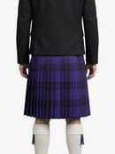 Person wearing a black jacket and purple plaid kilt on a white background