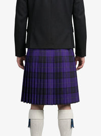Person wearing a black jacket and purple plaid kilt on a white background