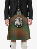 Person wearing a traditional Scottish kilt with a tartan pattern on a white background