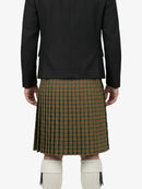 Person wearing a black jacket and green plaid kilt on a white background