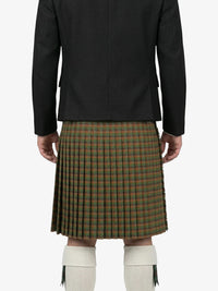 Person wearing a black jacket and green plaid kilt on a white background