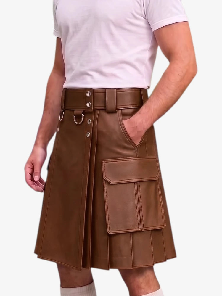 A man wearing a brown faux-leather kilt with a matching belt, silver-tone hardware, and a large front cargo pocket, paired with a white t-shirt and white socks, against a plain white background.