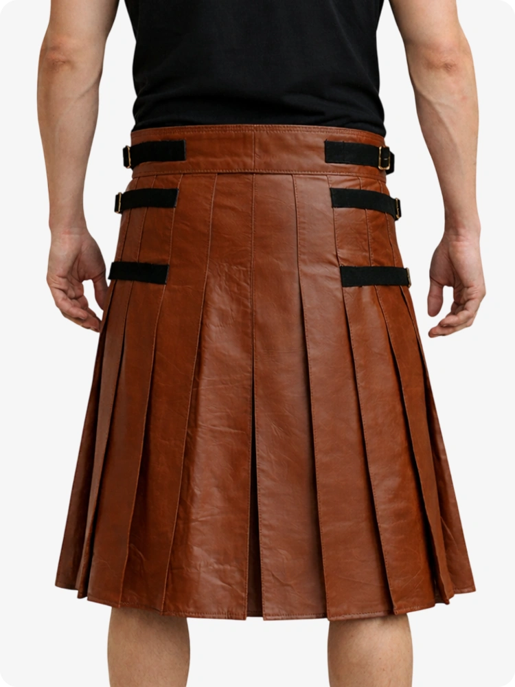 Brown leather kilt with black straps worn by a person on a white background