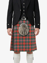 Person wearing a traditional Scottish kilt with a tartan pattern on a white background