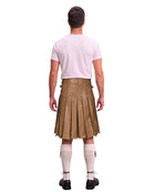 A man shown from the back wearing a light pink t-shirt, a brown pleated kilt, cream knee-high socks, and black shoes, against a solid white background.