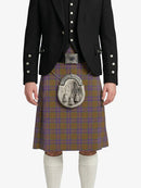 Person wearing a traditional Scottish kilt with a white background