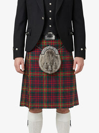 Person wearing a traditional Scottish kilt with a tartan pattern on a white background