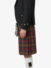 Person wearing a black jacket and red plaid kilt on a white background
