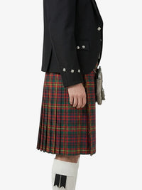 Person wearing a black jacket and red plaid kilt on a white background