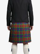Person wearing a black jacket and a colorful plaid kilt on a white background