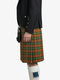 Person wearing a black jacket and green plaid kilt on a white background