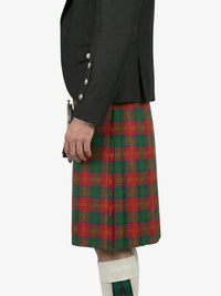Person wearing a dark jacket and red plaid kilt on a white background