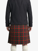 Person wearing a black coat and red plaid kilt on a white background