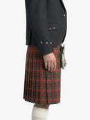 Person wearing a dark jacket and red plaid kilt on a white background