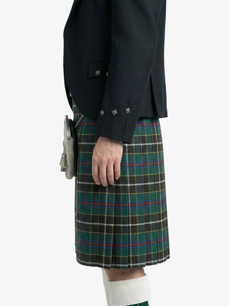 Person wearing a dark jacket and plaid kilt on a white background