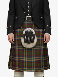 Person wearing a traditional Scottish kilt with a tartan pattern on a white background