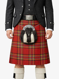 Person wearing a red tartan kilt with a black jacket and white knee-high socks on a white background