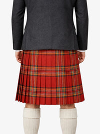 Person wearing a gray jacket and red plaid kilt on a white background
