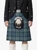 Person wearing a traditional Scottish kilt with a sporran on a white background