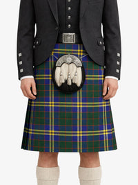 Person wearing a traditional Scottish kilt with a tartan pattern on a white background