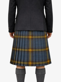 Person wearing a black coat and plaid kilt on a white background
