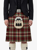 Person wearing a red plaid kilt with a matching jacket on a white background