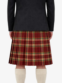 Person wearing a black jacket and red plaid kilt on a white background