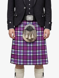 Person wearing a purple plaid kilt with a black jacket on a white background