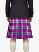 Person wearing a black jacket and purple plaid kilt on a white background