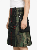 Person wearing a unique kilt with black and camouflage design on a white background
