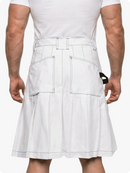 Person wearing a white kilt on a plain background