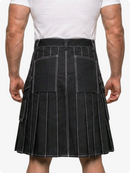 Person wearing a black pleated kilt on a white background