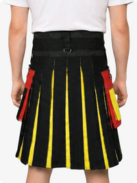 Black kilt with yellow and red accents worn by a person on a white background