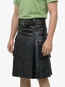 Person wearing a black leather kilt with a green shirt on a white background