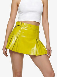 Person wearing a yellow pleated skirt and white top on a white background