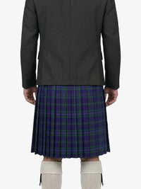 Person wearing a dark jacket and a blue plaid kilt on a white background