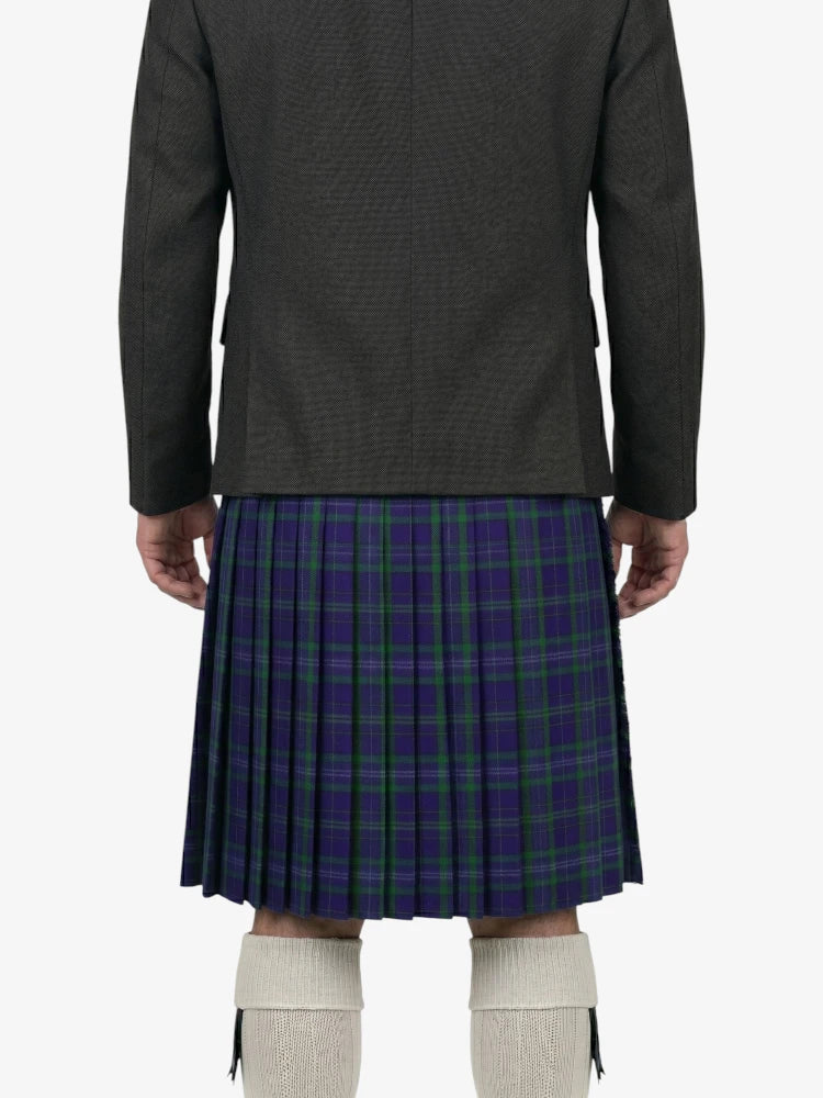 Person wearing a dark jacket and a blue plaid kilt on a white background