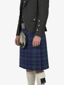 Person wearing a dark gray jacket and a plaid kilt on a white background