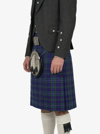Person wearing a dark gray jacket and a plaid kilt on a white background