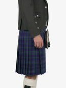 Person wearing a gray jacket and a purple plaid kilt on a white background