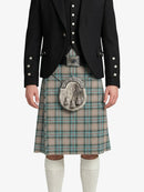 Person wearing a black jacket and plaid kilt on a white background