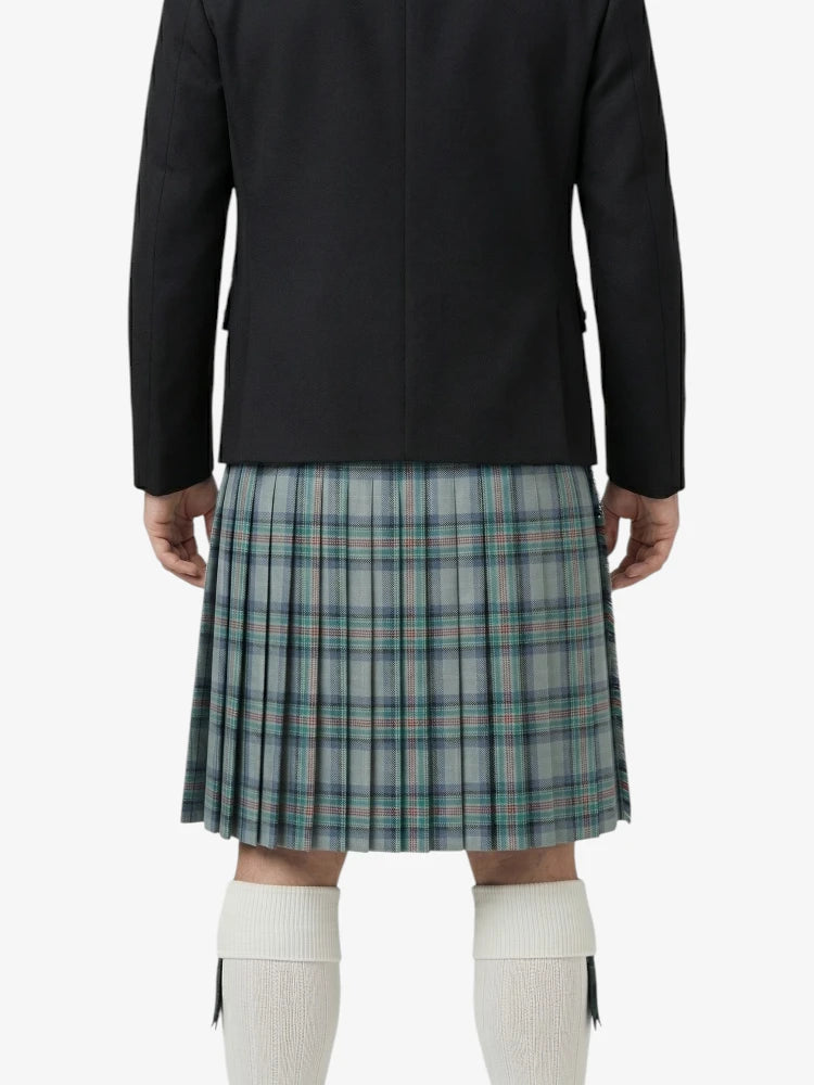 Person wearing a black jacket and plaid kilt on a white background