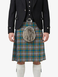 Person wearing a Scottish kilt with a tartan pattern on a white background