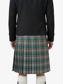 Person wearing a black jacket and plaid kilt on a white background