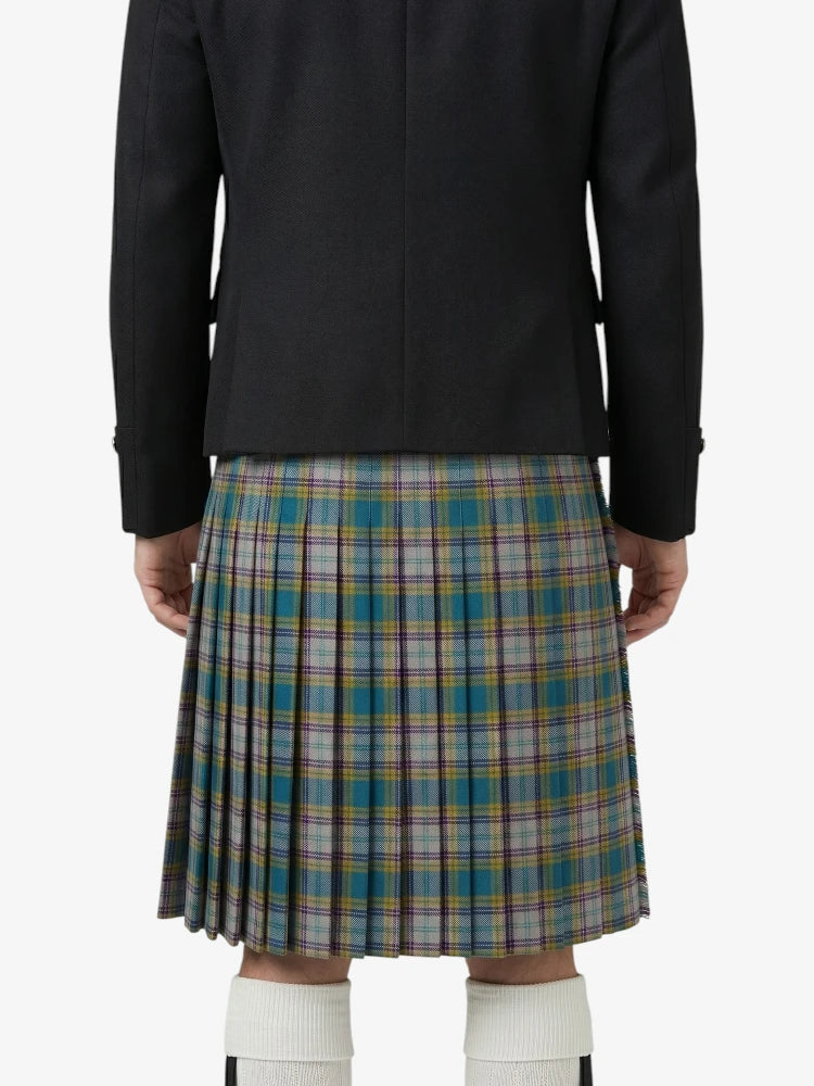 Person wearing a black jacket and plaid kilt on a white background