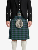 Person wearing a traditional Scottish kilt with a tartan pattern on a white background