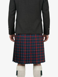Person wearing a dark jacket and red plaid kilt on a white background